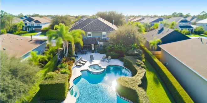 Aerial view of a beautiful pool home in Lakeland FL surrounded by lush greenery