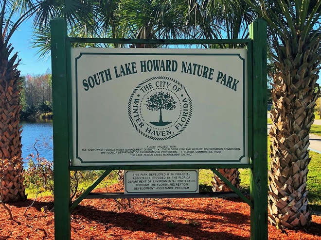 Serene lake surrounded by lush greenery at South Lake Howard Nature Park